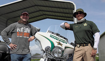 Brehne Next To Cop Motorcycle